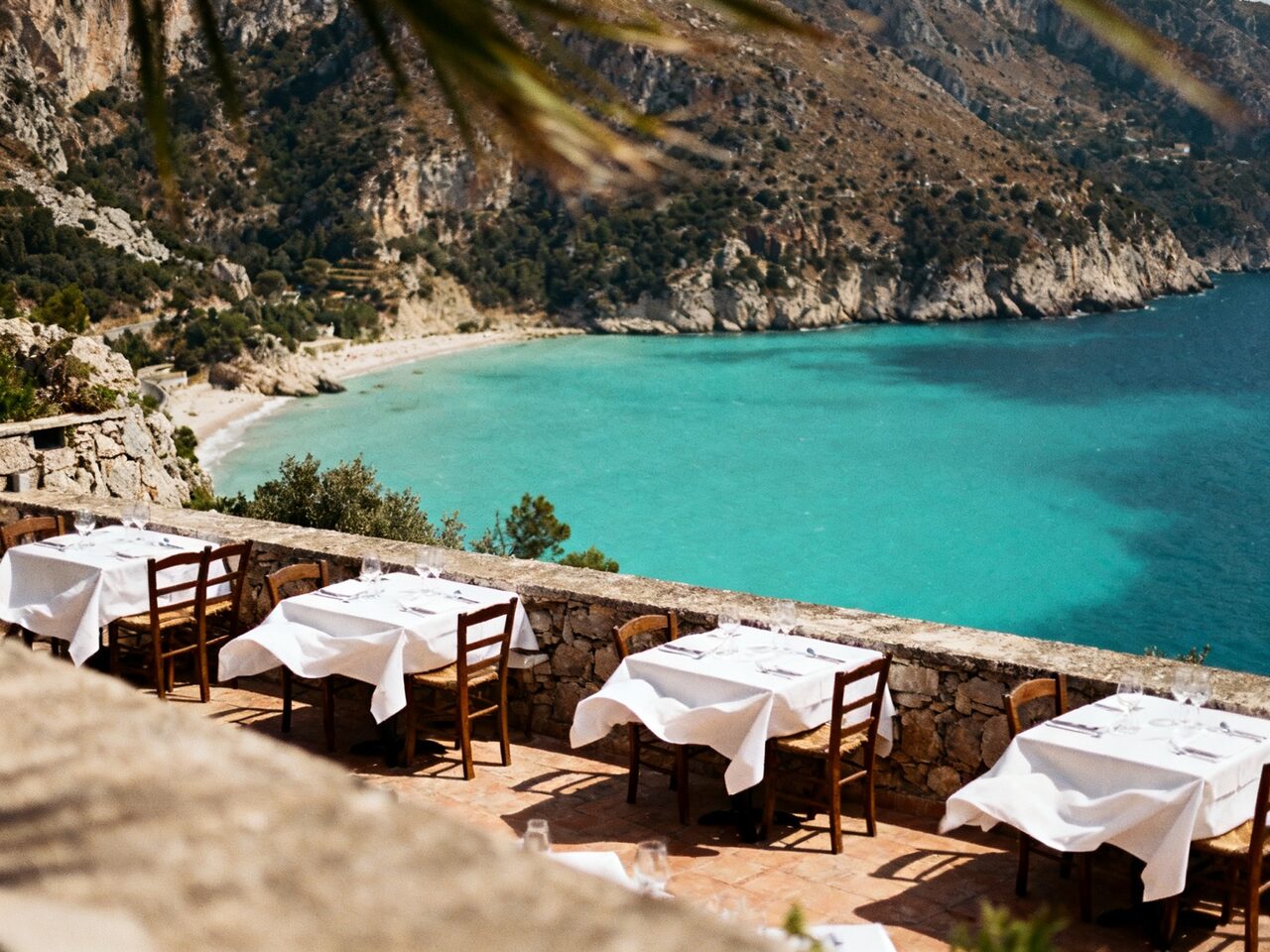 cliffside restaurant terrace above a bay generated with Seedream 4.0 in Made